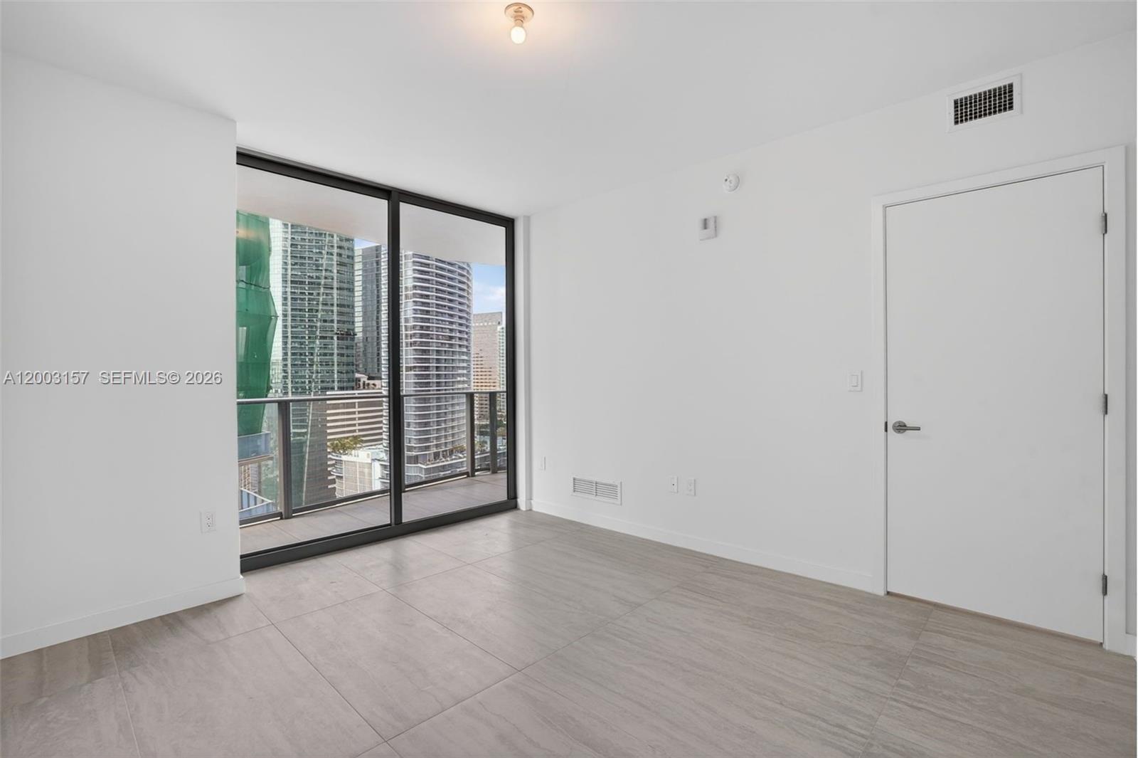77 Southeast 5th Street, Unit 2705 Miami, FL 33131 - Photo 12 of 45 a view of a room with an empty room