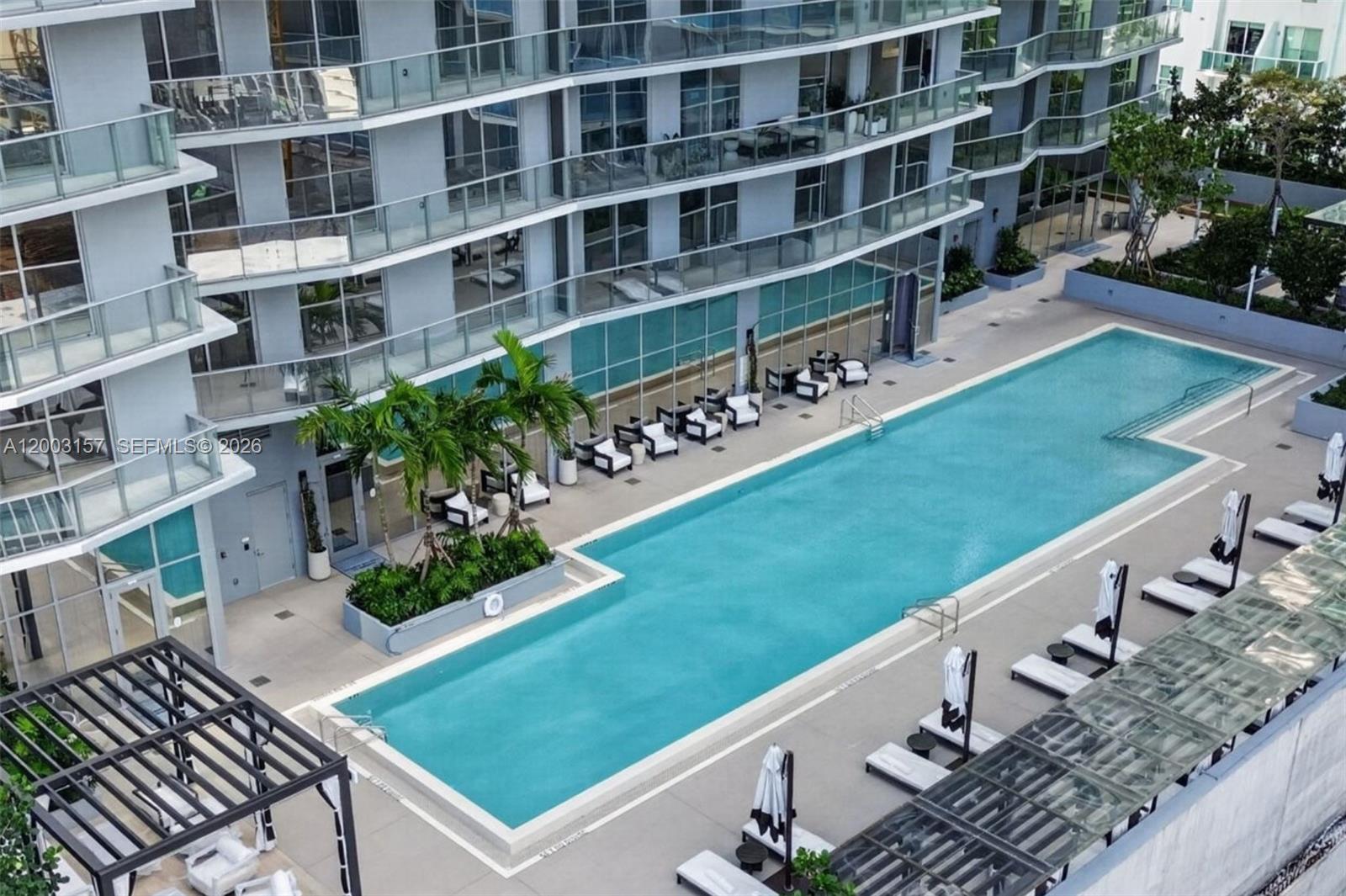 77 Southeast 5th Street, Unit 2705 Miami, FL 33131 - Photo 21 of 45 a view of a patio with plants and large trees