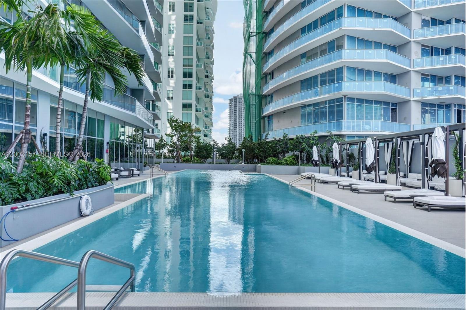 77 Southeast 5th Street, Unit 2705 Miami, FL 33131 - Photo 23 of 45 a view of a swimming pool with a patio