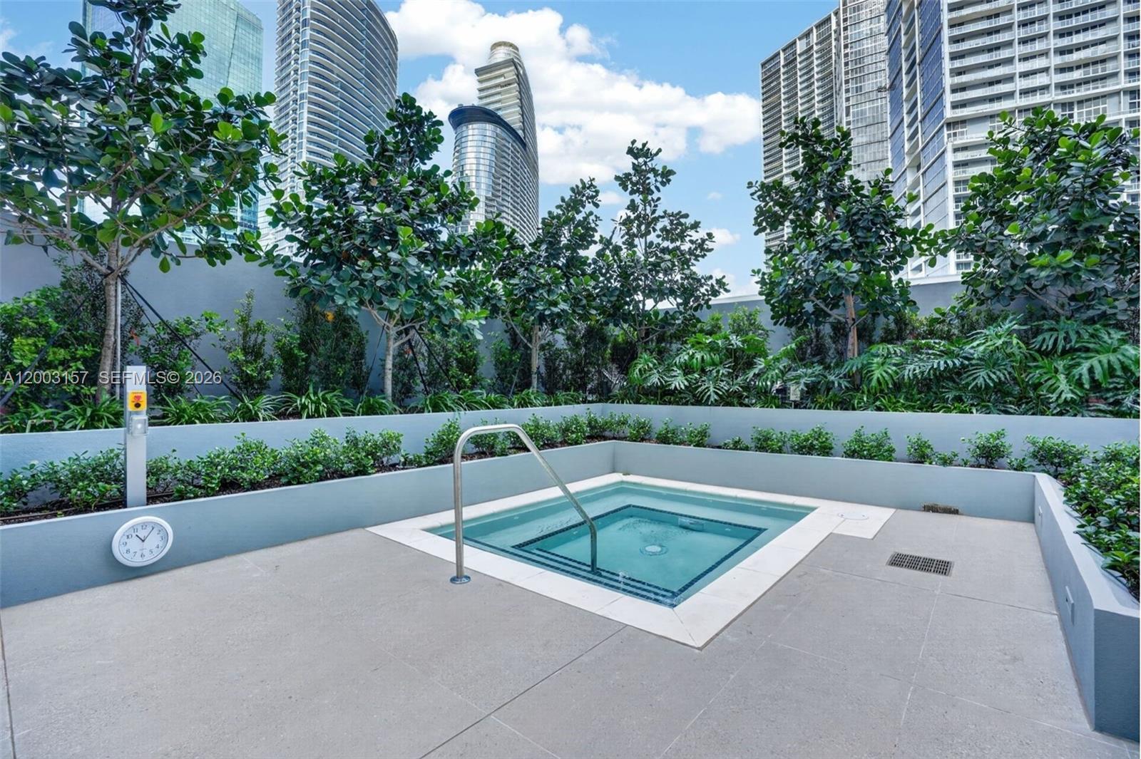 77 Southeast 5th Street, Unit 2705 Miami, FL 33131 - Photo 24 of 45 a view of a pool with a bench in a yard