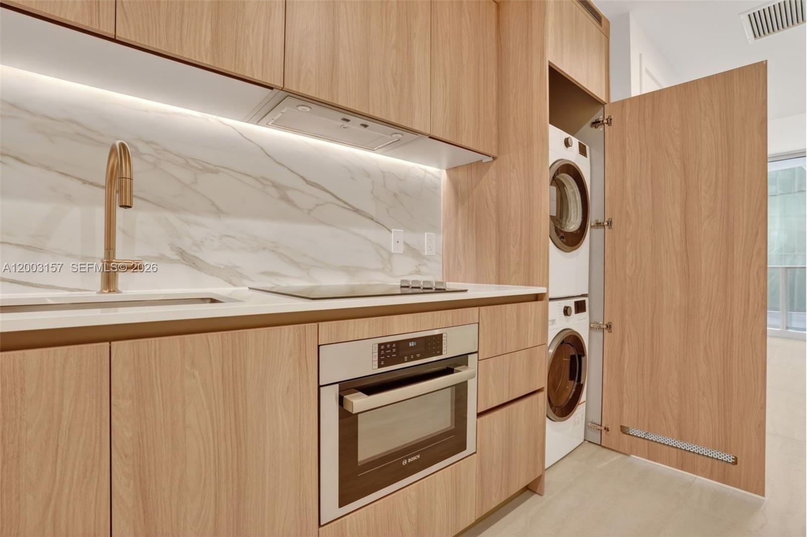 77 Southeast 5th Street, Unit 2705 Miami, FL 33131 - Photo 4 of 45 a utility room with dryer and washer