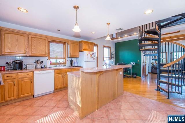 551 Washington Street, Unit 2 Carlstadt, NJ 07072 - Photo 7 of 19 a kitchen with stainless steel appliances granite countertop a refrigerator a sink a stove and island