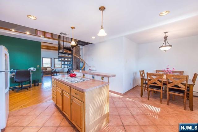 551 Washington Street, Unit 2 Carlstadt, NJ 07072 - Photo 8 of 19 a kitchen that has a lot of cabinets a sink and a wooden floor in it