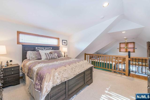 551 Washington Street, Unit 2 Carlstadt, NJ 07072 - Photo 10 of 19 a bedroom with a bed and a chandelier