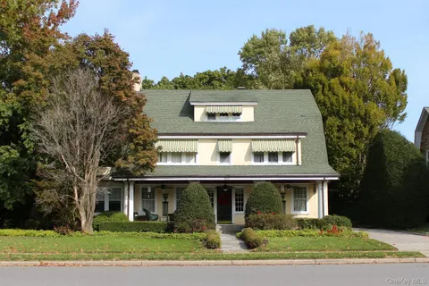 a front view of house with trees