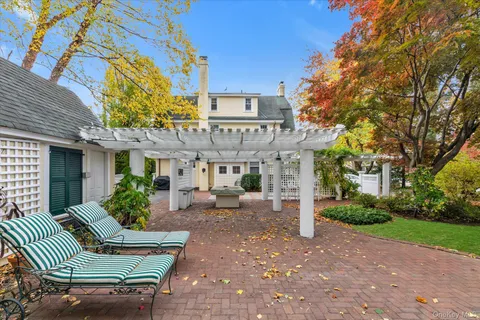 a front view of a house with garden and patio