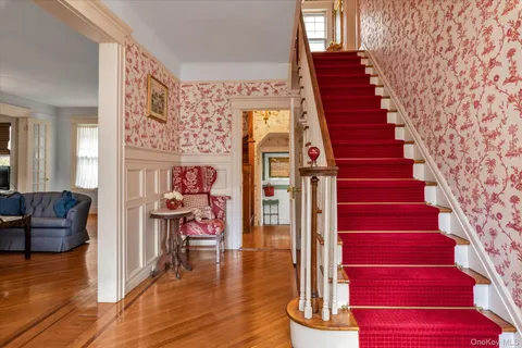 a view of entryway and hall with wooden floor