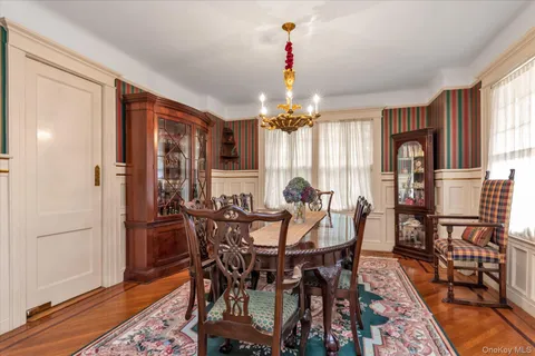 a view of a dining room with furniture and wooden floor