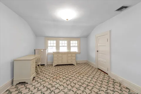 a bathroom with a sink toilet and window