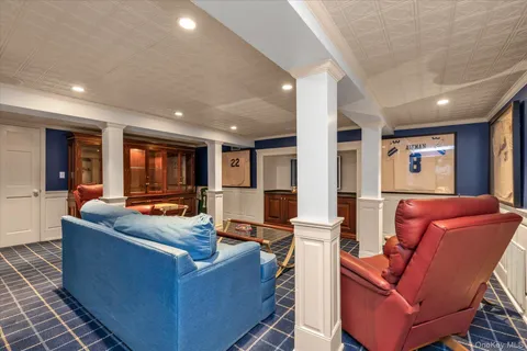 a living room with furniture a large window and a fireplace