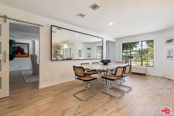 a dining room with furniture and wooden floor