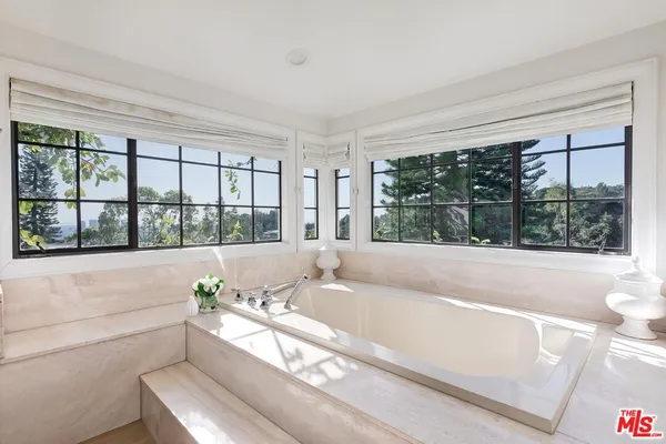 a bath tub sitting in front of a window