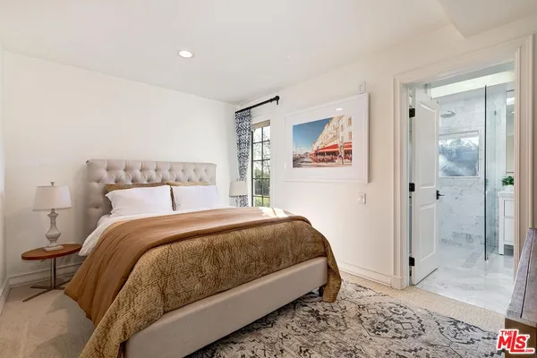 a bedroom with a bed and glass door