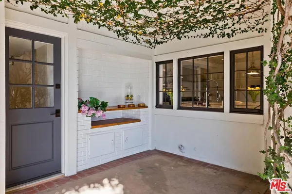 a view of a swimming pool with lawn chairs under an umbrella