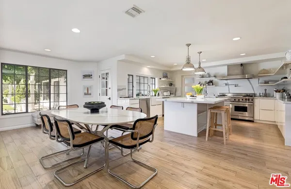a large kitchen with a table and chairs