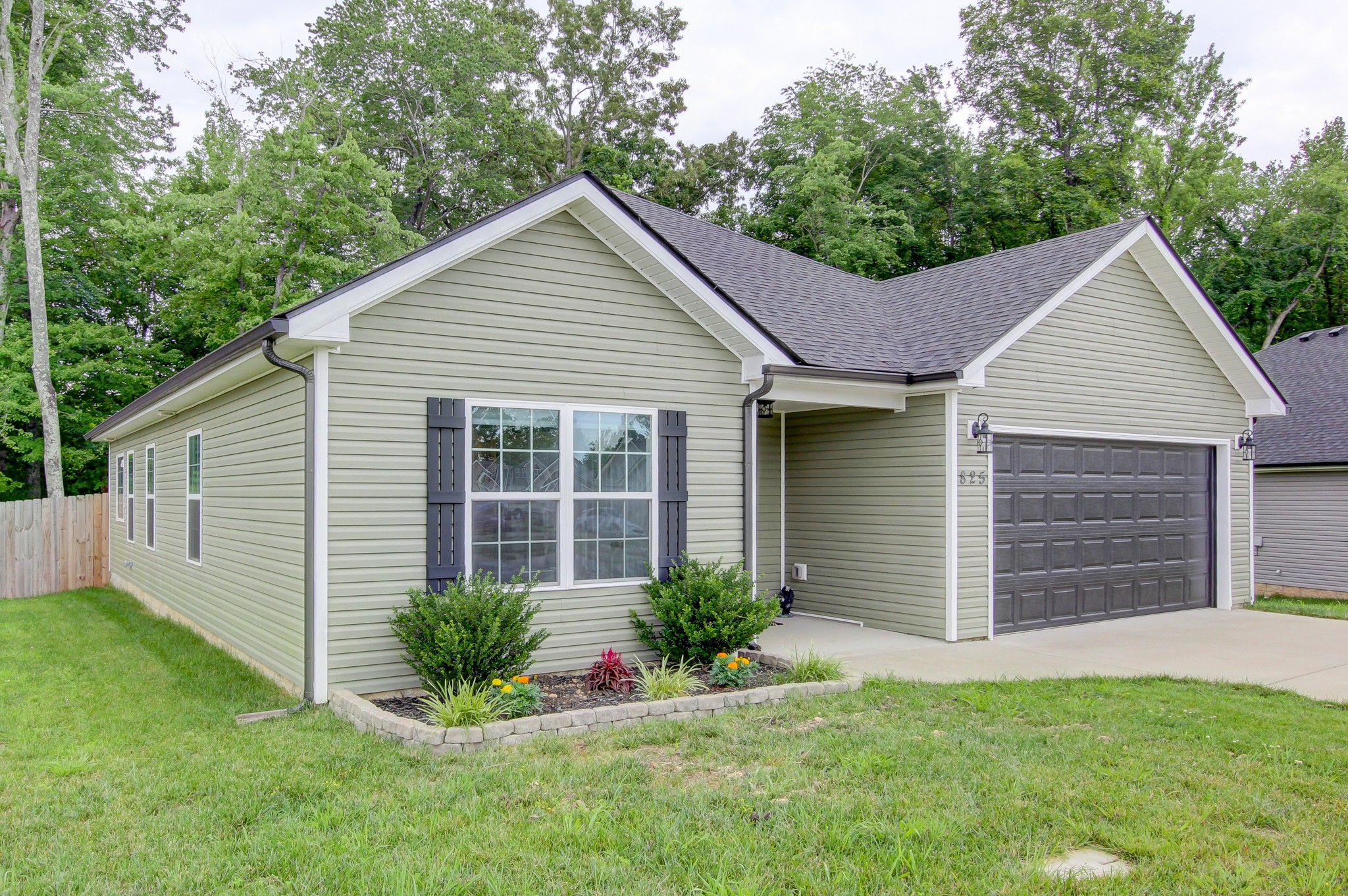 825 Rushing Drive Clarksville, TN 37042 - Photo 2 of 70 a view of a house with a yard plants and large tree