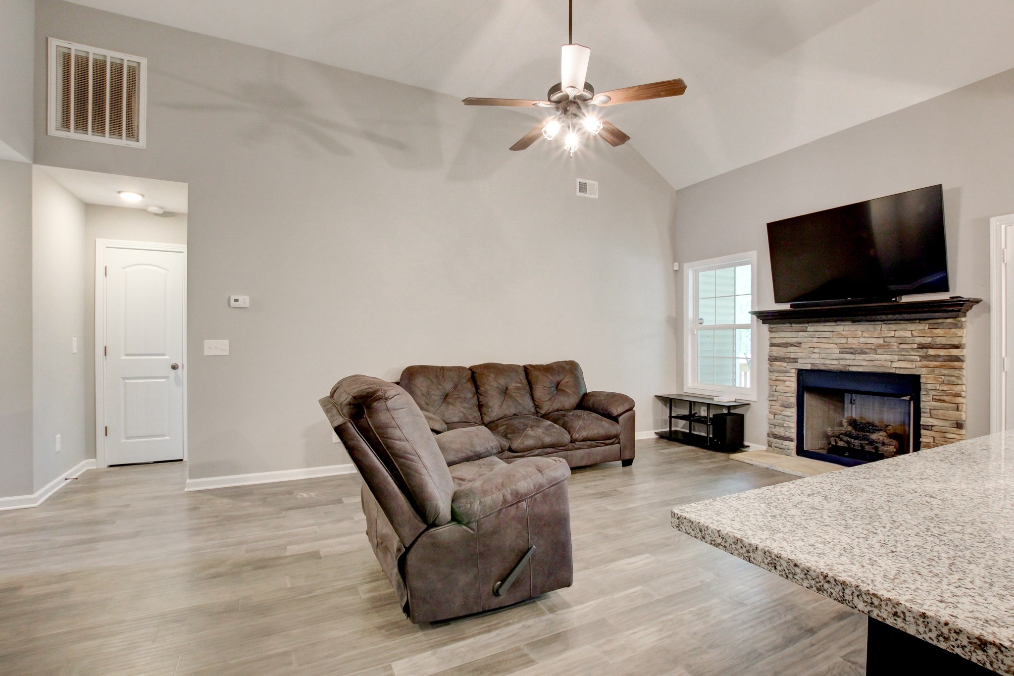 825 Rushing Drive Clarksville, TN 37042 - Photo 23 of 70 a living room with furniture a fireplace and a flat screen tv