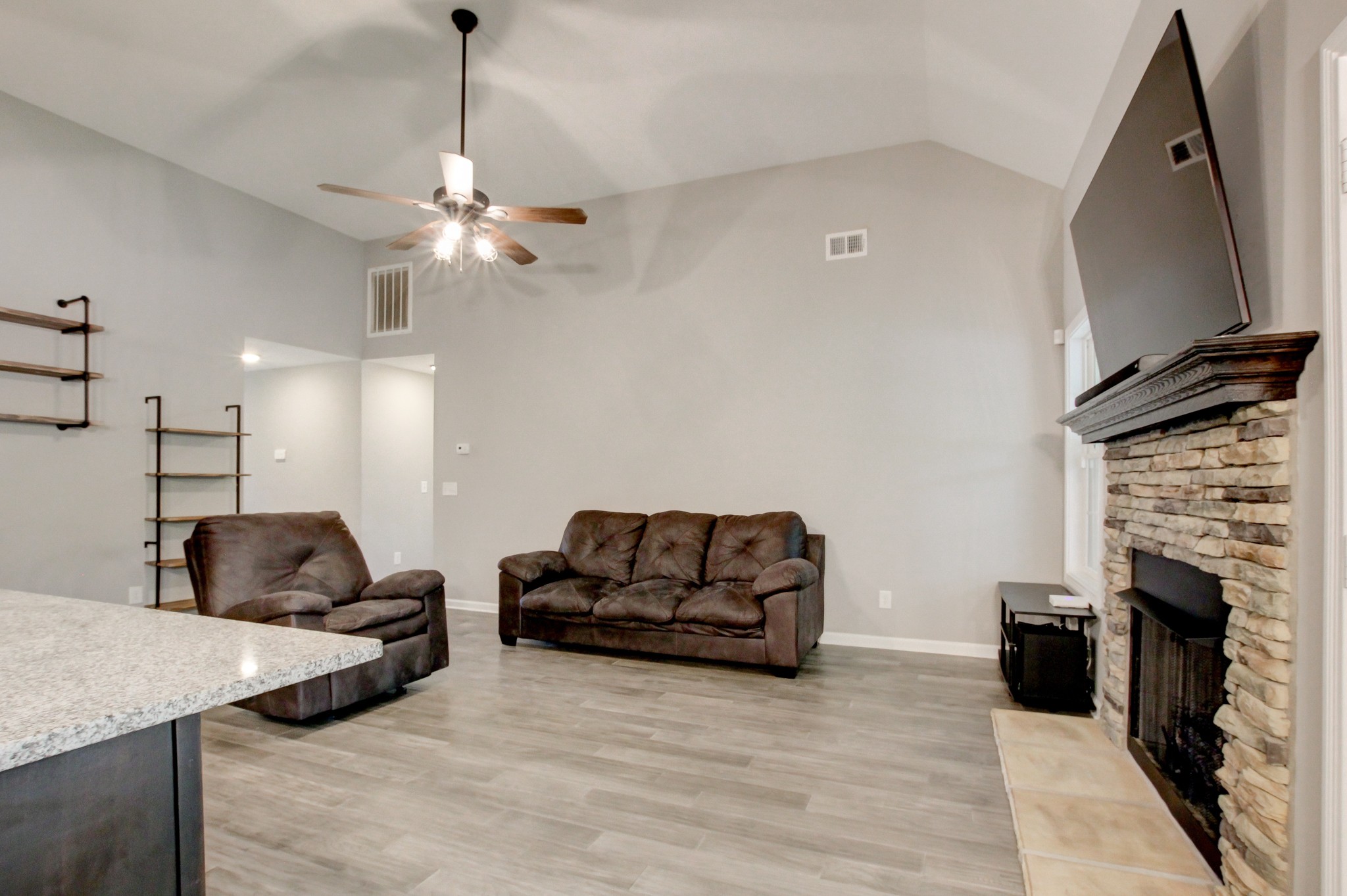 825 Rushing Drive Clarksville, TN 37042 - Photo 24 of 70 a living room with furniture a fireplace and a flat screen tv