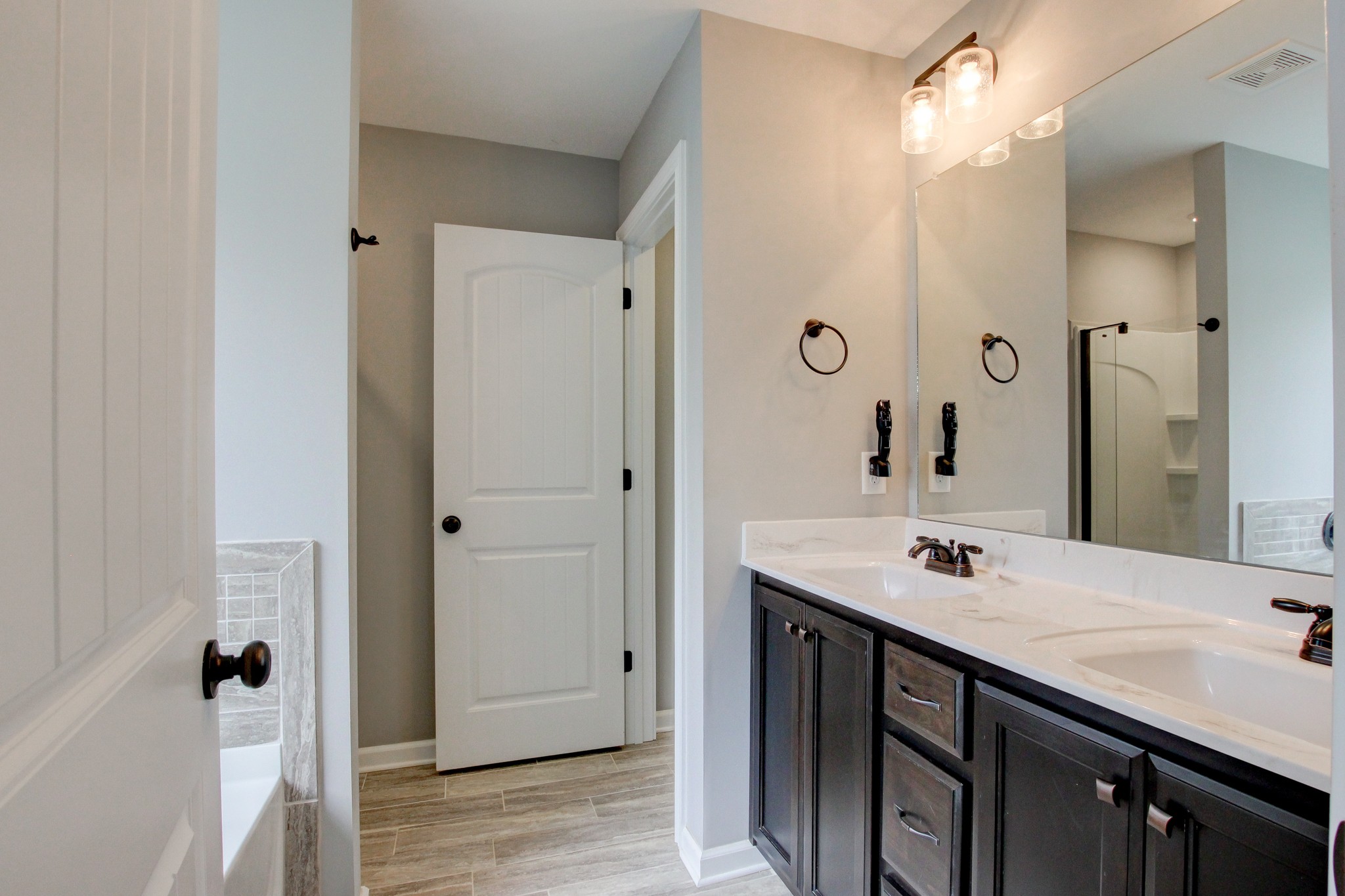 825 Rushing Drive Clarksville, TN 37042 - Photo 58 of 70 a bathroom with a sink a mirror and a shower