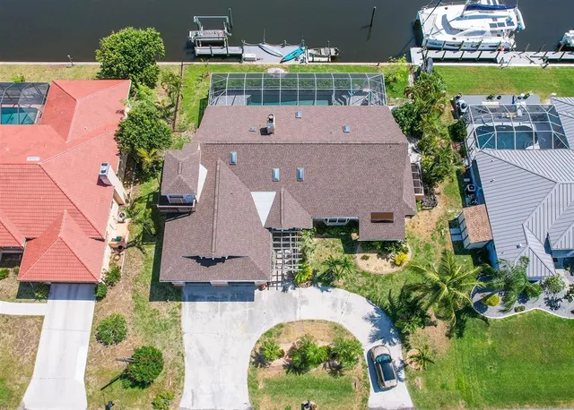 an aerial view of a house with a garden and swimming pool