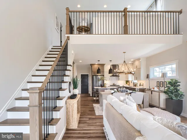 a living room with furniture fireplace and white walls