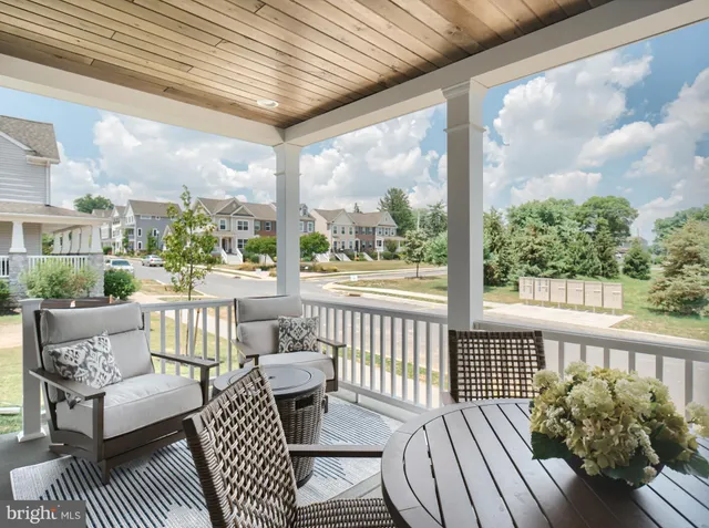 a view of a chair and tables in the balcony