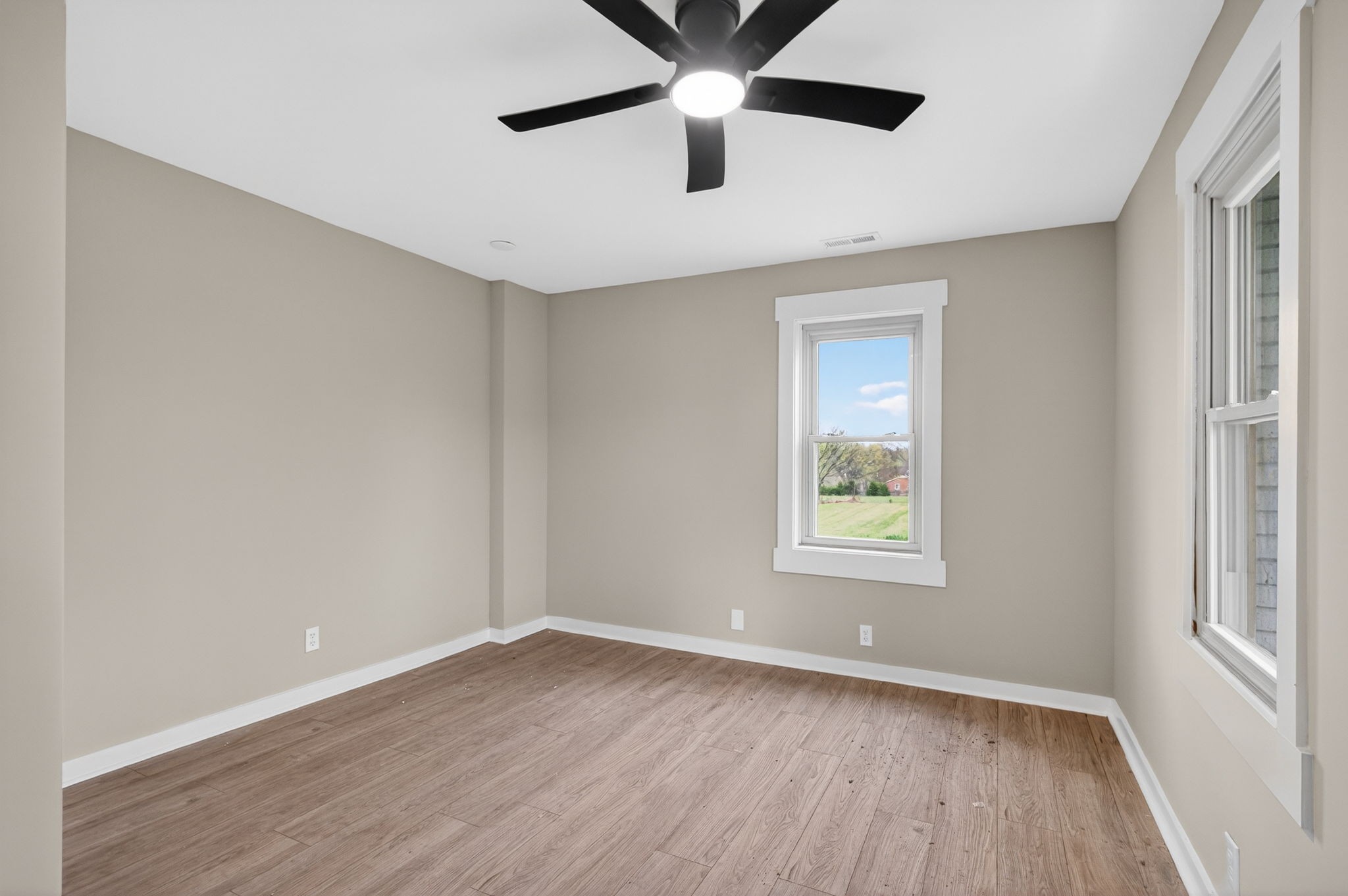 946 Clearview Road Cottontown, TN 37048 - Photo 12 of 33 a view of an empty room with wooden floor and a window