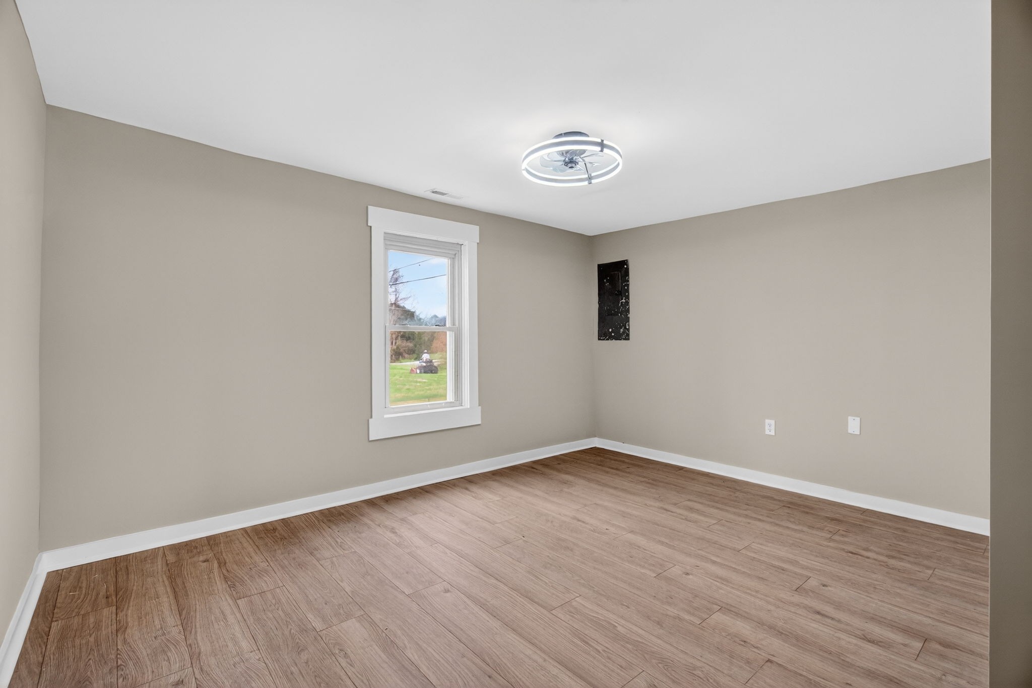 946 Clearview Road Cottontown, TN 37048 - Photo 20 of 33 an empty room with wooden floor and windows