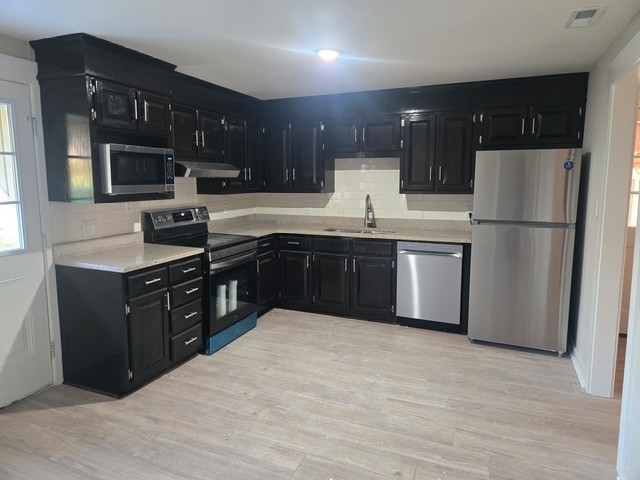 946 Clearview Road Cottontown, TN 37048 - Photo 5 of 33 a kitchen with stainless steel appliances granite countertop a sink stove and refrigerator