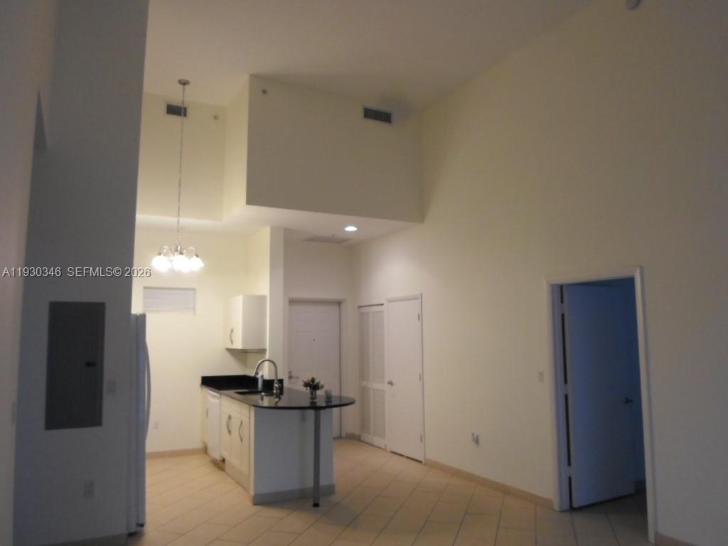 7275 Southwest 90th Way, Unit G 611 Miami, FL 33156 - Photo 32 of 56 a kitchen with stainless steel appliances kitchen island a stove a refrigerator and a sink