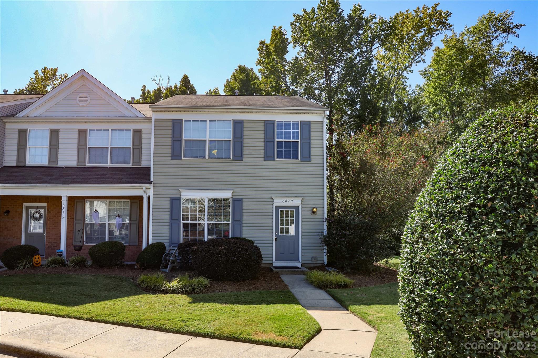 a front view of a house with a yard and outdoor seating