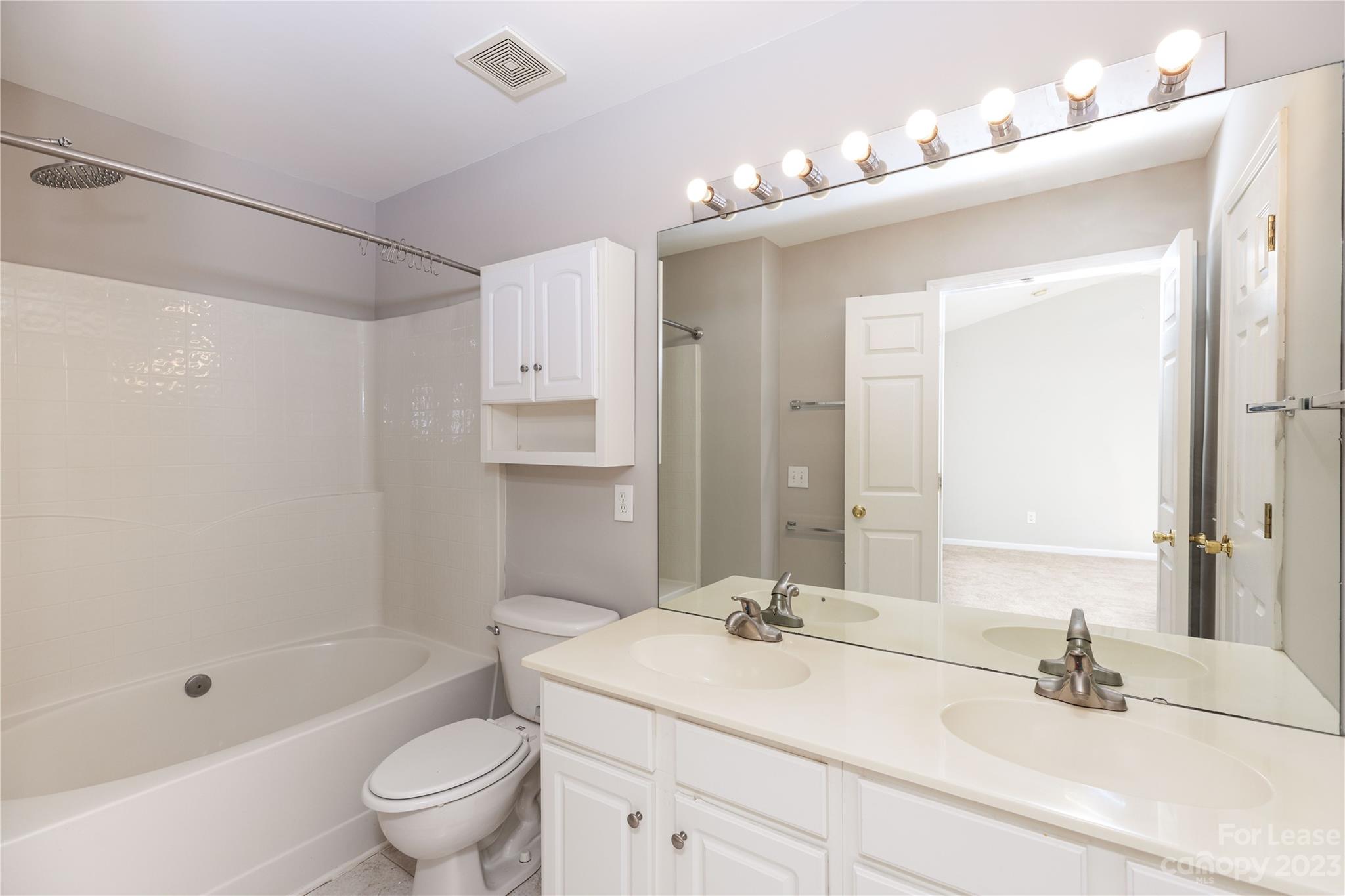6879 Rothchild Drive Charlotte, NC 28270 - Photo 14 of 19 a bathroom with a sink a toilet and shower