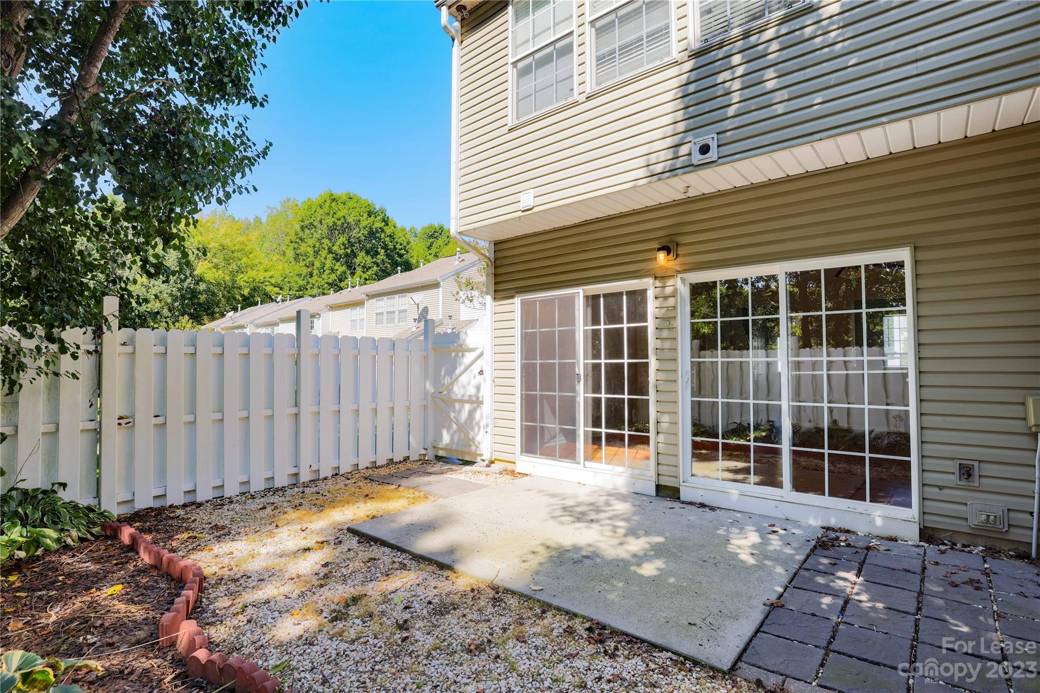6879 Rothchild Drive Charlotte, NC 28270 - Photo 17 of 19 a view of a backyard with a fence