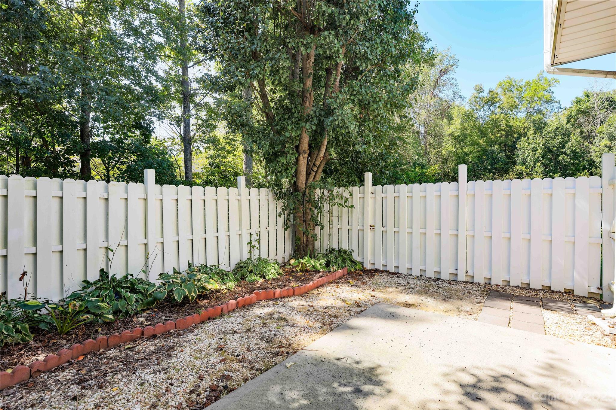 6879 Rothchild Drive Charlotte, NC 28270 - Photo 18 of 19 a view of a backyard with wooden fence