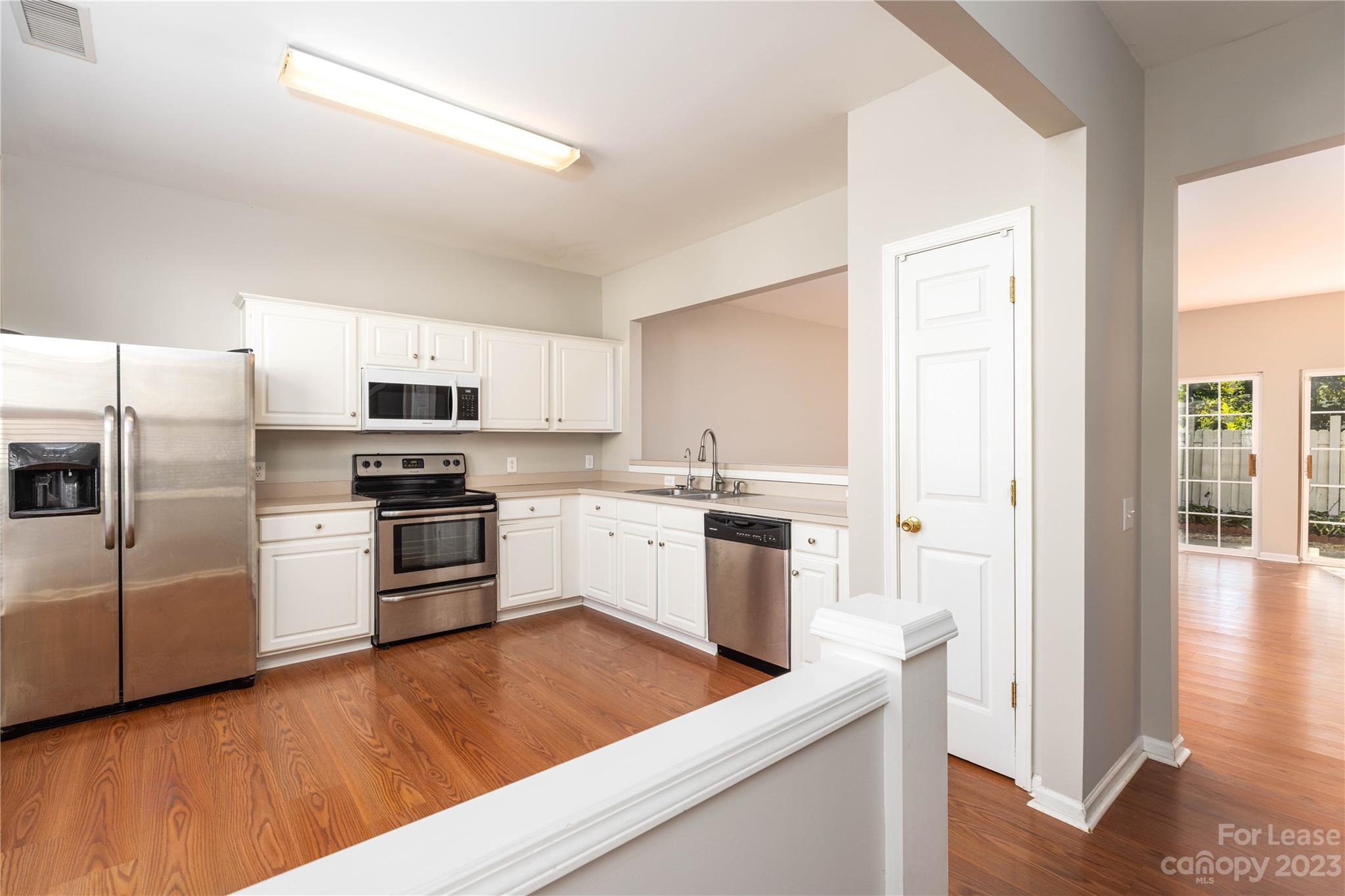 6879 Rothchild Drive Charlotte, NC 28270 - Photo 2 of 19 a kitchen with white cabinets and stainless steel appliances