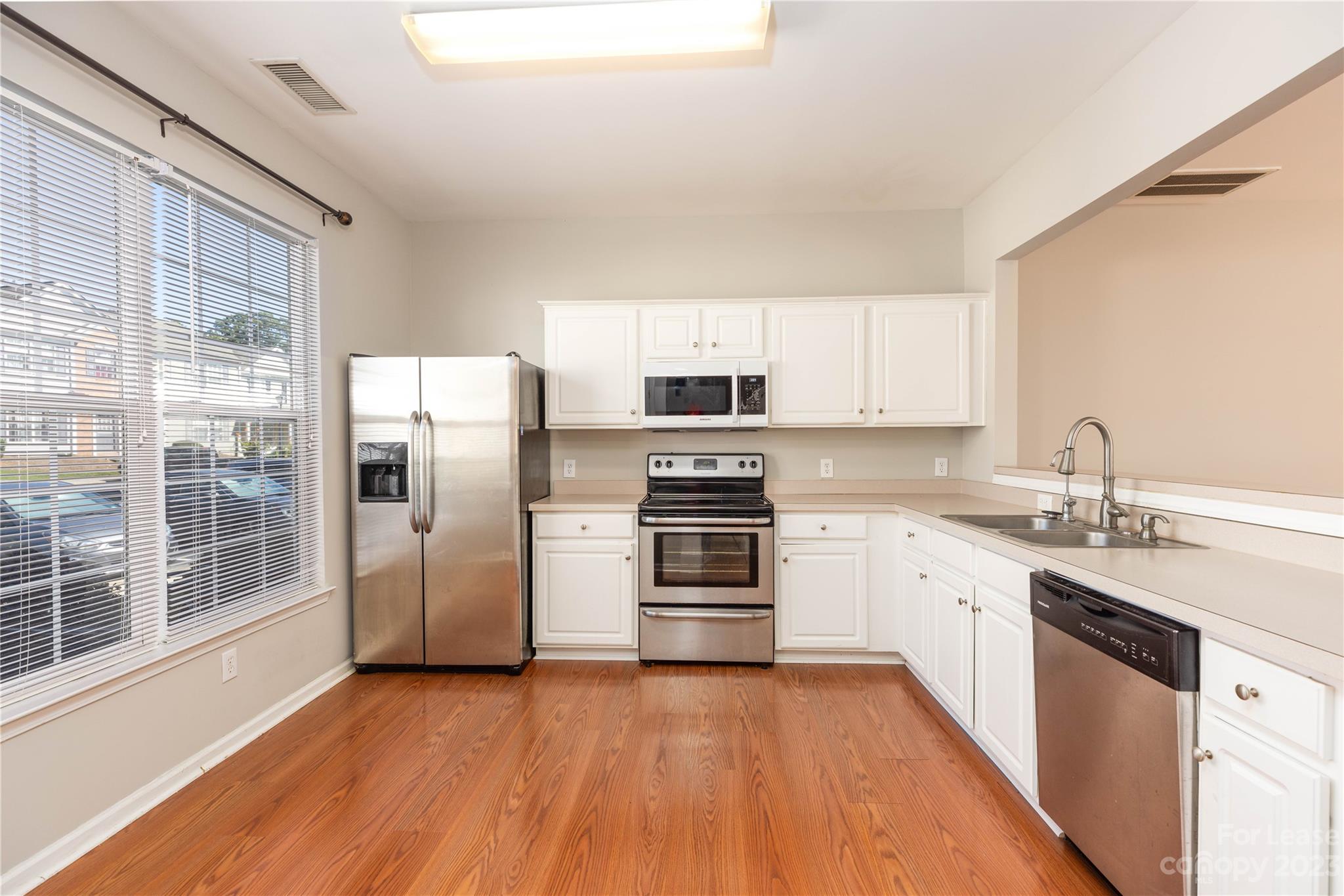 6879 Rothchild Drive Charlotte, NC 28270 - Photo 3 of 19 a kitchen with granite countertop a refrigerator and a sink