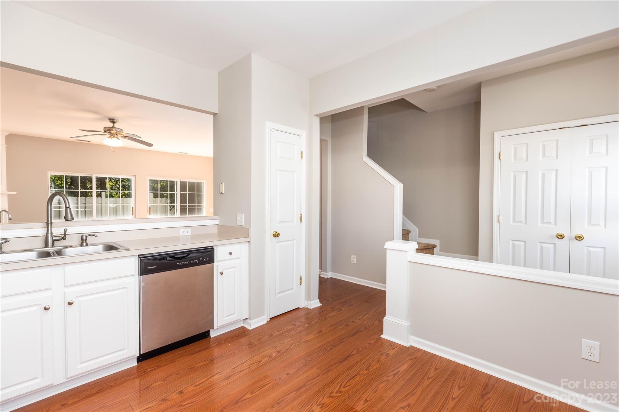 6879 Rothchild Drive Charlotte, NC 28270 - Photo 5 of 19 a kitchen with stainless steel appliances granite countertop a sink cabinets and wooden floor
