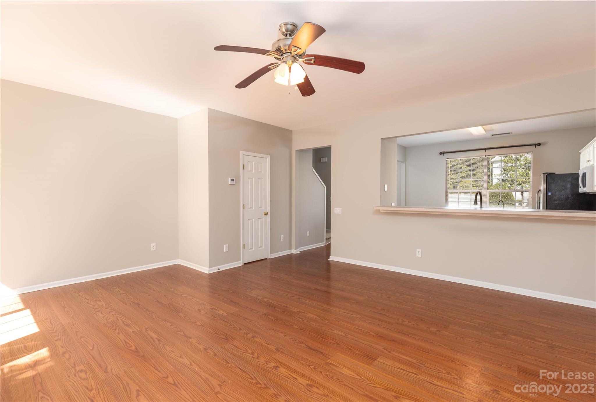 6879 Rothchild Drive Charlotte, NC 28270 - Photo 9 of 19 a view of an empty room with window and a kitchen