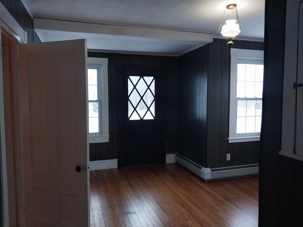 49 Salem Street, Unit 1 Haverhill, MA 01835 - Photo 13 of 16 a view of empty room with wooden floor and fan