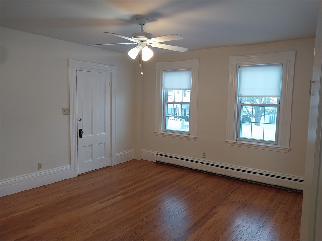 49 Salem Street, Unit 1 Haverhill, MA 01835 - Photo 14 of 16 a view of an empty room with wooden floor and a window