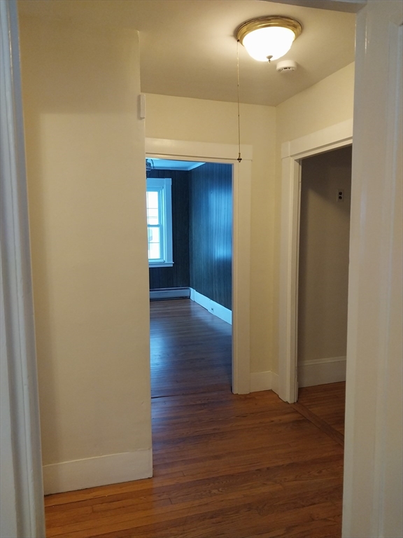 49 Salem Street, Unit 1 Haverhill, MA 01835 - Photo 9 of 16 a view of a hallway with wooden floor