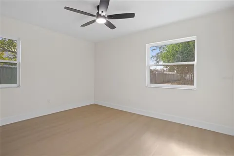 an empty room with chandelier fan