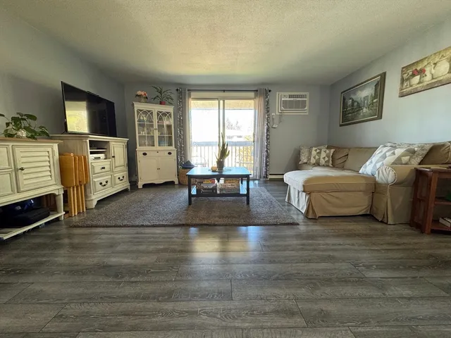 a living room with furniture window and a flat screen tv