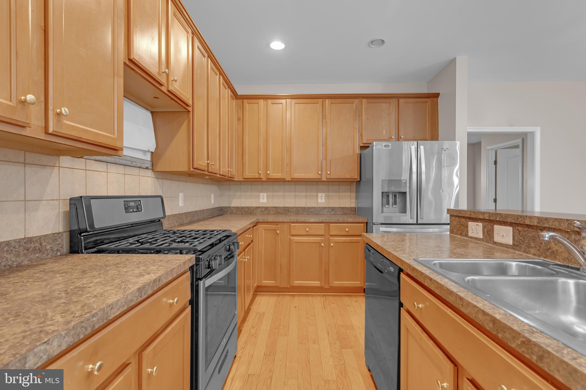 626 Tailgate Terrace Landover, MD 20785 - Photo 12 of 36 a kitchen with stainless steel appliances granite countertop a sink stove and refrigerator