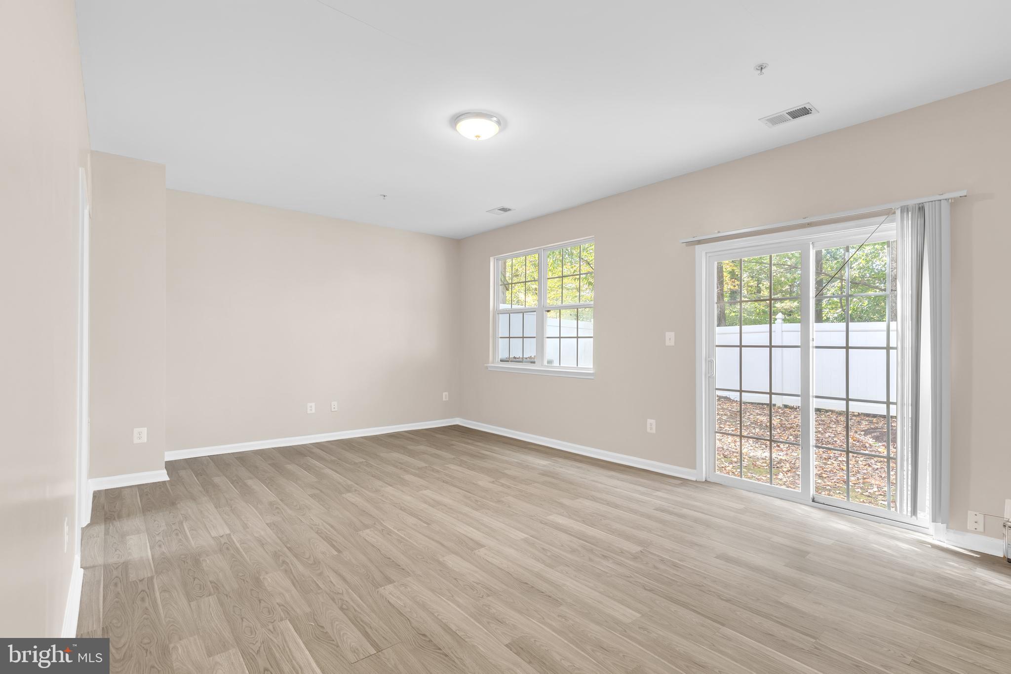 626 Tailgate Terrace Landover, MD 20785 - Photo 29 of 36 an empty room with wooden floor and windows