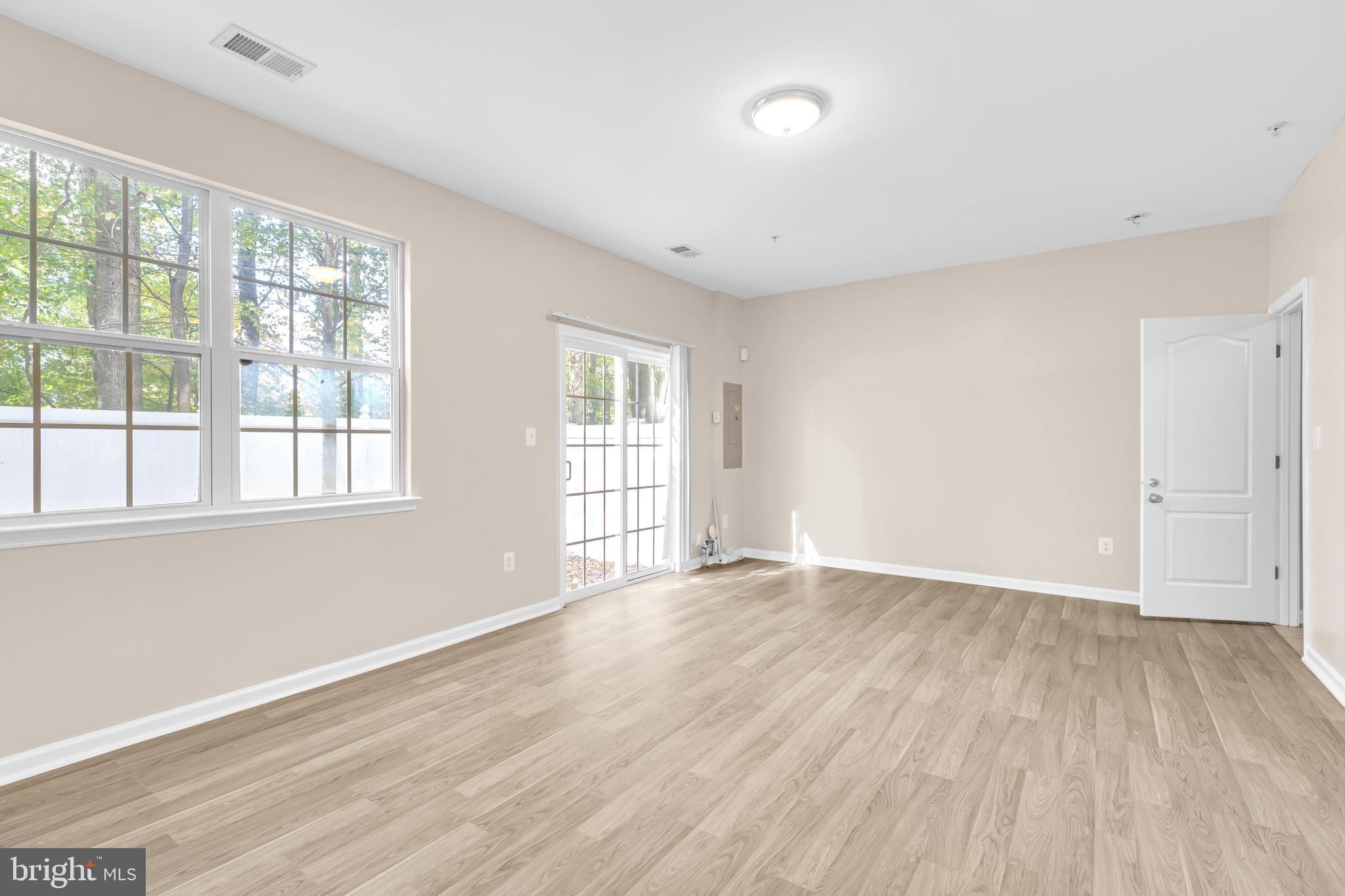 626 Tailgate Terrace Landover, MD 20785 - Photo 31 of 36 an empty room with wooden floor and windows