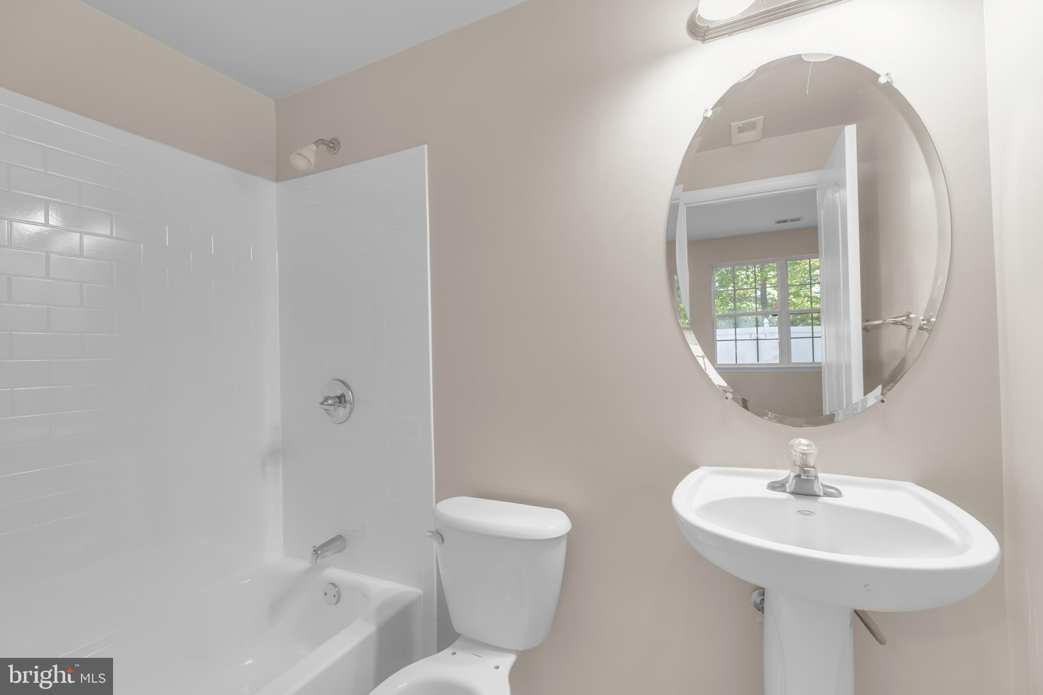 626 Tailgate Terrace Landover, MD 20785 - Photo 32 of 36 a bathroom with a toilet sink and mirror