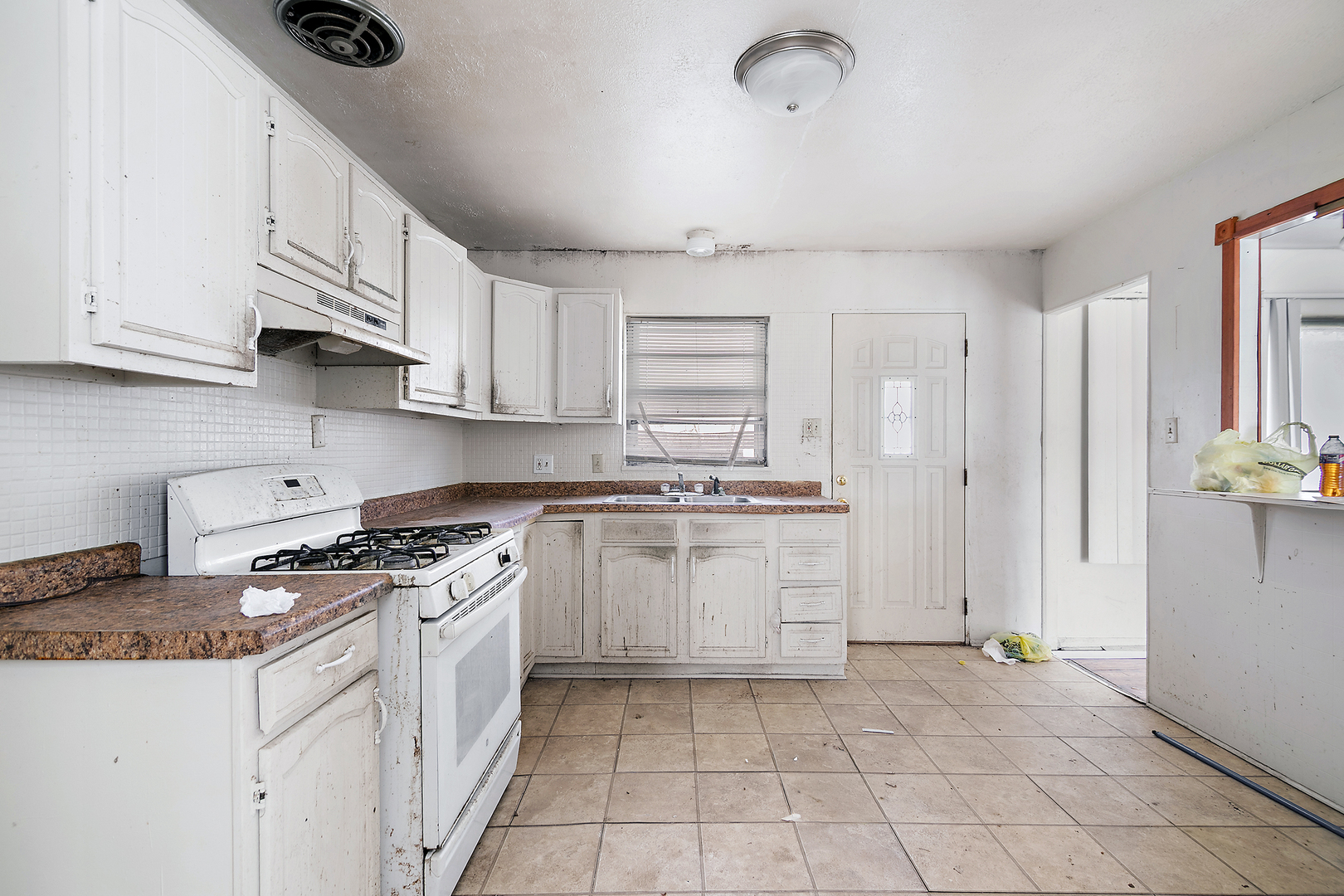 1869 Summit Avenue Kankakee, IL 60901 - Photo 13 of 13 a kitchen with white cabinets and appliances