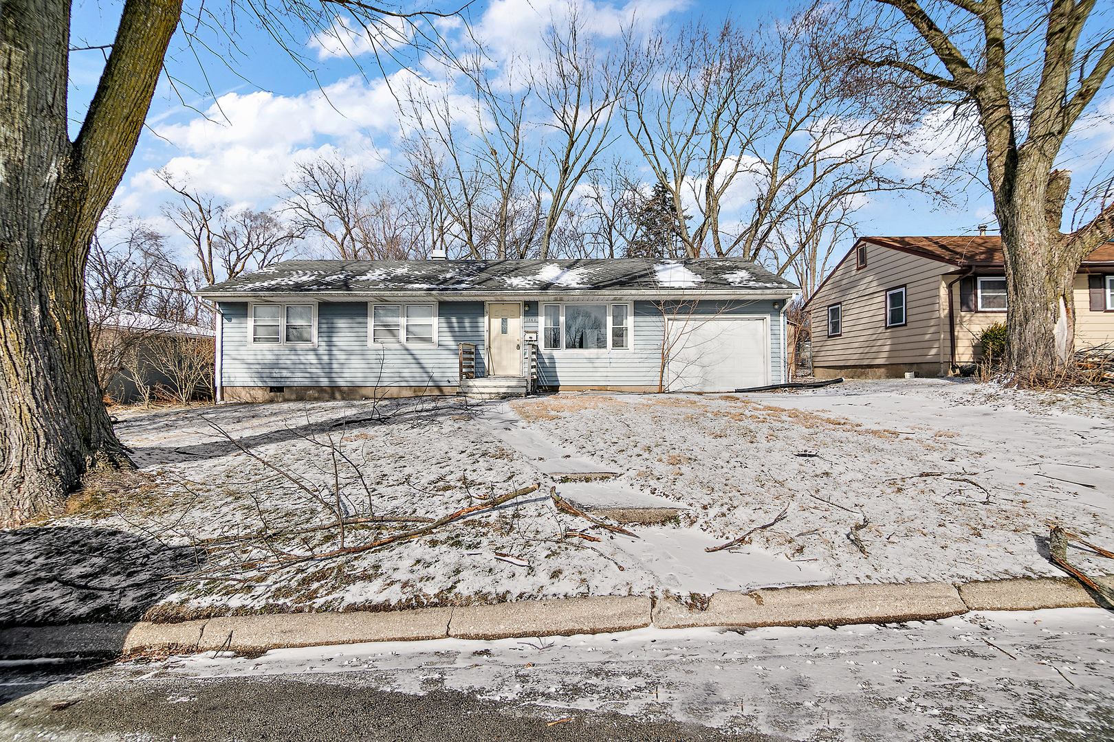 1869 Summit Avenue Kankakee, IL 60901 - Photo 3 of 13 a front view of a house with a yard covered in snow
