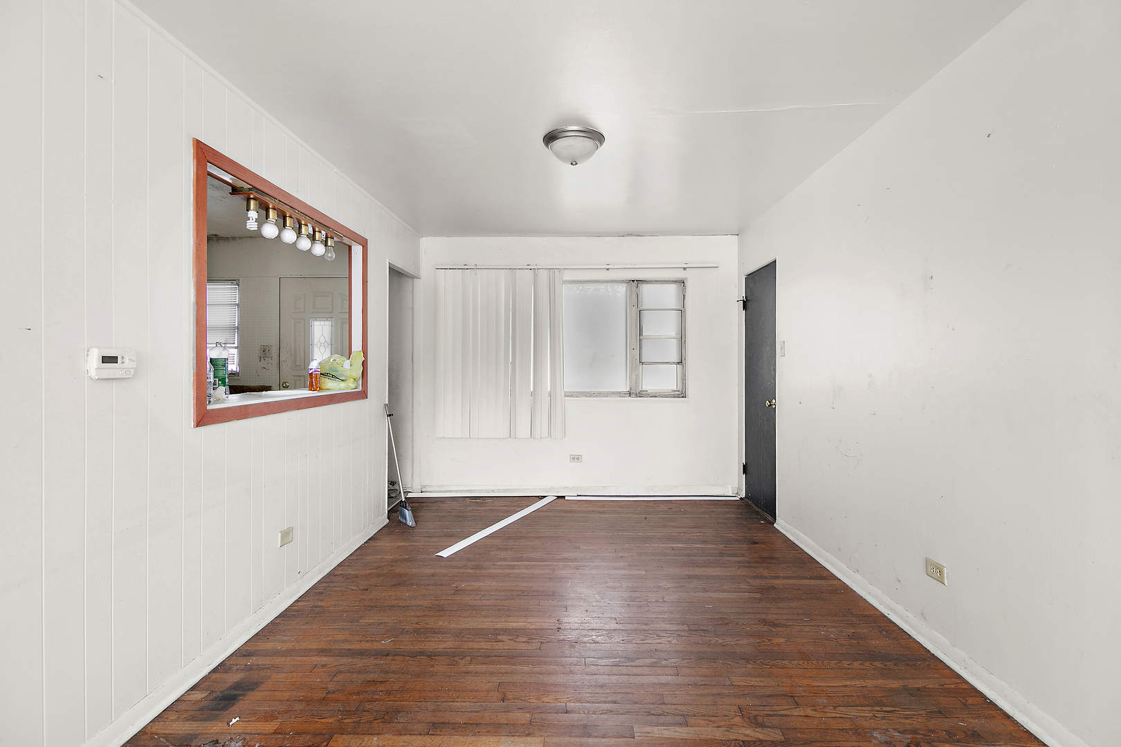 1869 Summit Avenue Kankakee, IL 60901 - Photo 10 of 13 a view of an empty room with wooden floor and a window
